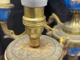 a blue and gold vase and a gold and white lamp