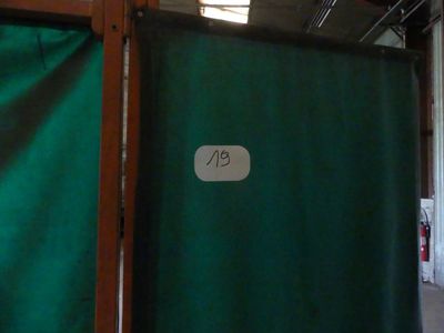 a green curtain with a number on it in a room