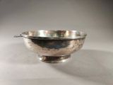 an antique silver plated bowl on a white surface