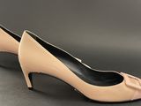 a close up of a pair of nude colored shoes on a gray surface