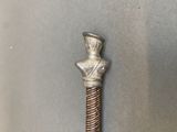 a silver and red cane with a head on it