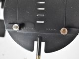 a close up of a clock on a white wall