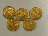 four gold sovereigns of different sizes and shapes on a white surface