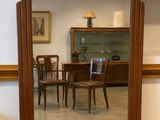 a mirror that is sitting on the floor in front of a table