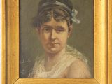 portrait d'une jeune femme coiffée d'un chapeau bleu, devant un mur blanc