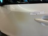 a sticker on the door of a white car