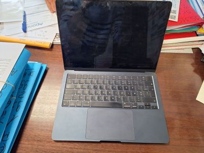 a laptop computer sitting on top of a wooden desk