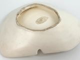 a white vase that is sitting on a table