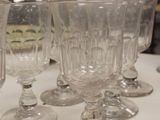 several empty wine glasses sitting on top of a white table