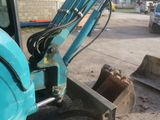 a blue excavator that is parked in the dirt