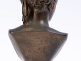an antique bronze bust of a woman on a pedestal