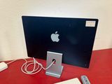 an apple computer sitting on a red table with a keyboard and mouse