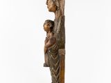 a wooden statue of a woman holding a child