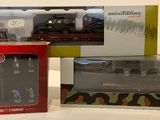 two boxes of toy trains sitting on a table