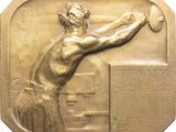 bronze plaque of a woman throwing a tennis ball with a racquet