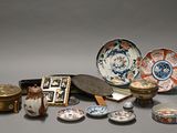 many different types of asian plates and bowls on the table