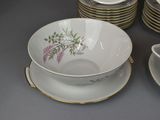 a lot of plates and cups that are on the table
