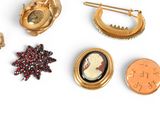 many different types of brooches and pins on a white surface