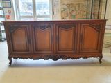 a large wooden cabinet in the middle of a room