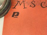 a mouse and headphones sitting on top of a piece of paper