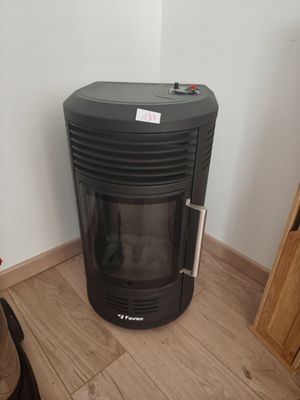 a black stove in the corner of a room