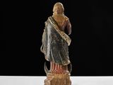 an old statue of a man with a beard and a robe