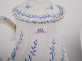 a white and blue tea pot with a lid