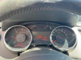 a close up of a car dashboard with gauges and a steering wheel