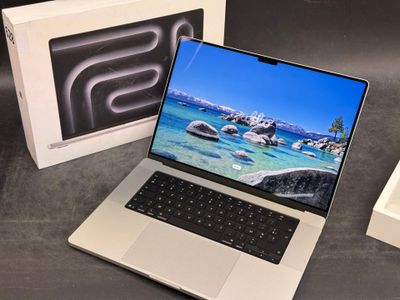 a laptop that is sitting on a table next to a box