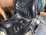 a close up of a seat on a vehicle in a garage