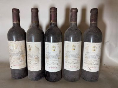 four bottles of wine are lined up on a table
