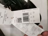 a person holding a ticket and a pair of headphones