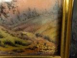 a picture of a painting of a landscape in a gold frame