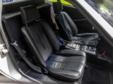 a picture of the inside of a car with black leather seats