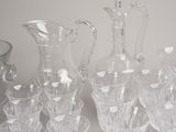 a lot of glasses and a pitcher on the table