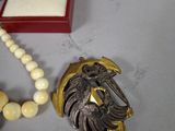 a necklace with a ring and a necklace with a lion on it