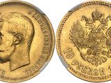 a close up of a gold coin with a man ' s face on it
