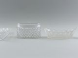 several pieces of glass sitting on top of a table next to each other