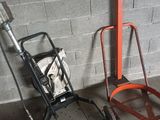 a small hand truck and a dolly in a garage