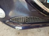 a close up of a car ' s front grill and headlight
