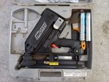 a box with a stapler, stapler, and other items in it