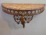 a small table with a marble top on a wall