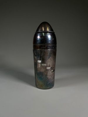 an image of a silver vase sitting on top of a table