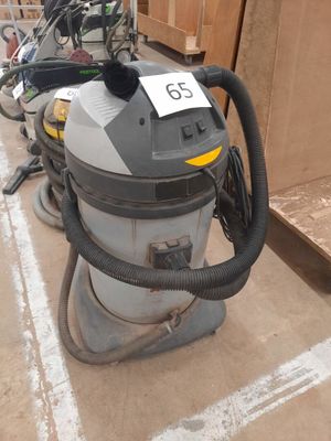 a vacuum that is sitting on the floor next to other items