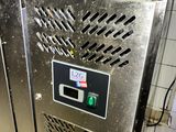 a machine that is sitting in a kitchen with a lot of stuff on it