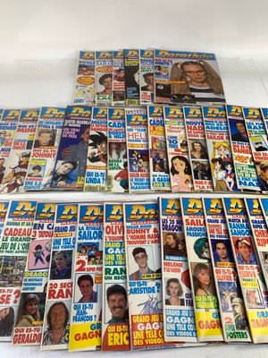 a pile of magazines sitting on top of a white table