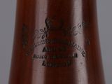 a close up of a brown vase on a table