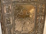 an old silver metal box with a cross on the front of it
