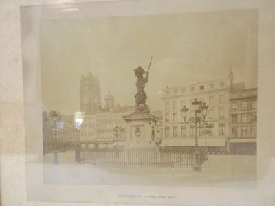 a picture of a picture of a statue in the middle of a city