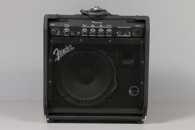 an amplifier sitting on top of a table next to a white wall